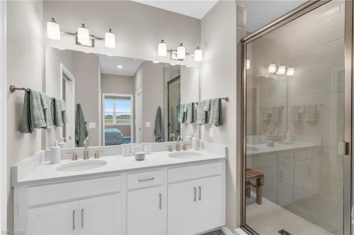 Bathroom featuring an enclosed shower and vanity