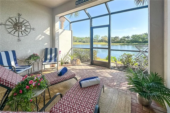 Sunroom / solarium featuring a water view