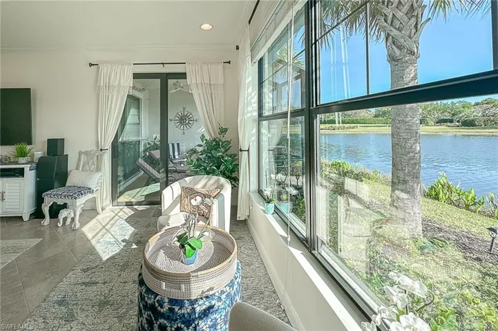 Sunroom with a healthy amount of sunlight and a water view