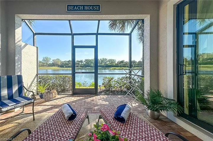 Sunroom / solarium featuring a water view