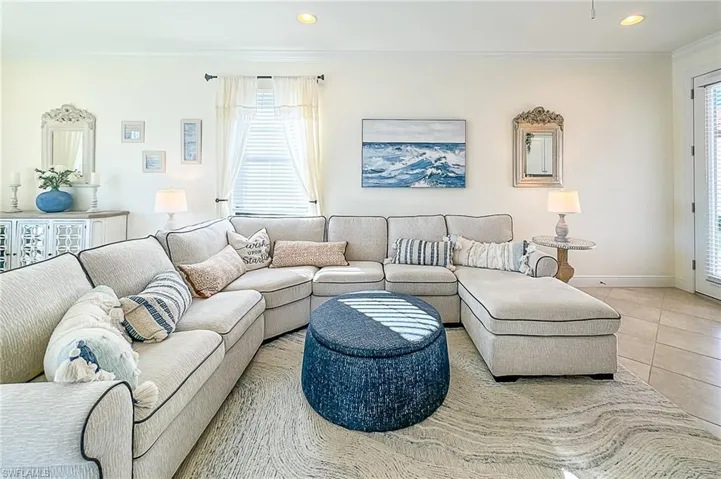 Living room with crown molding and tile flooring
