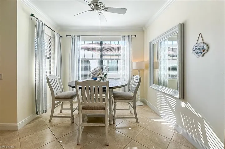 Dining space with a wealth of natural light, light tile flooring, and ceiling fan