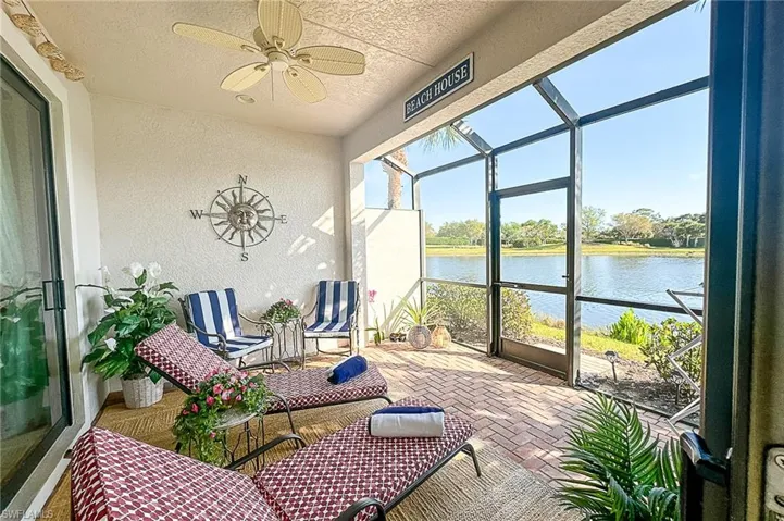 Sunroom featuring a water view and ceiling fan