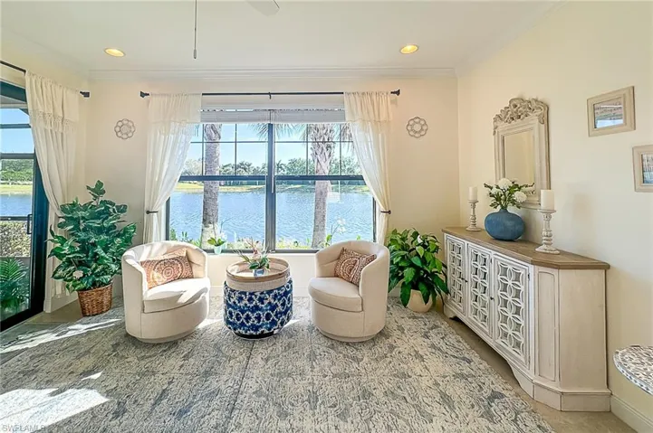 Sitting room featuring crown molding and a water view