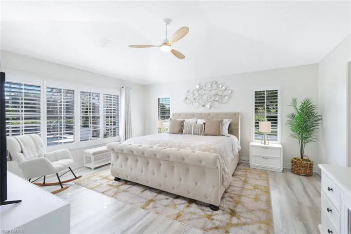 Bedroom featuring vaulted ceiling, light wood-type flooring, and ceiling fan