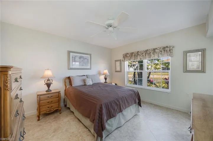 Bedroom featuring ceiling fan and baseboards