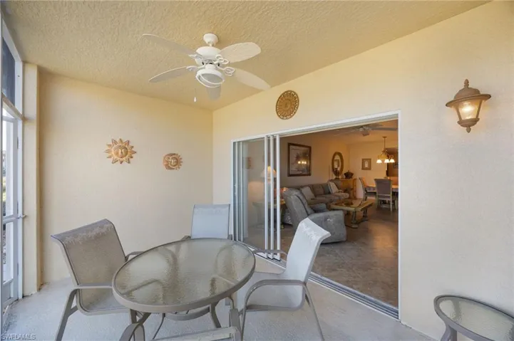 Sunroom featuring outdoor dining area and a ceiling fan