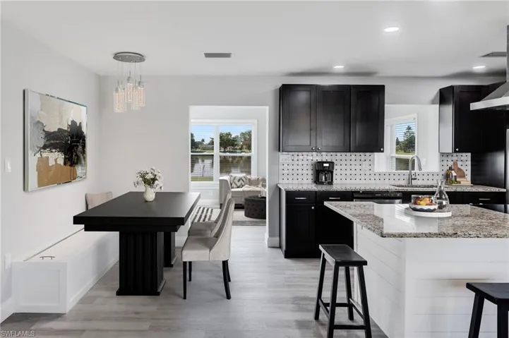 Dining area with built-in bench storage seating. Virtually staged.