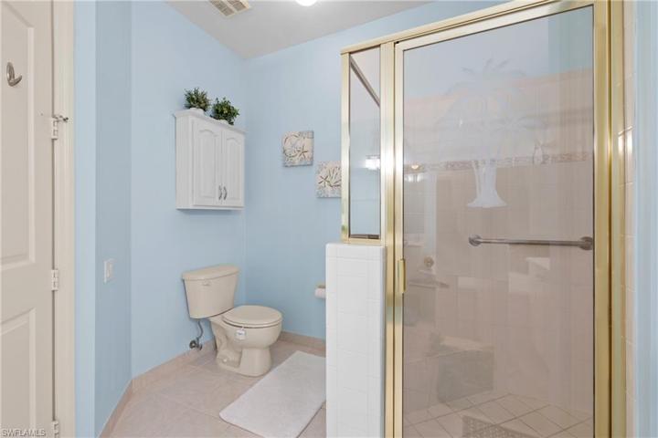 Walk in shower with dual shower heads and grab bar