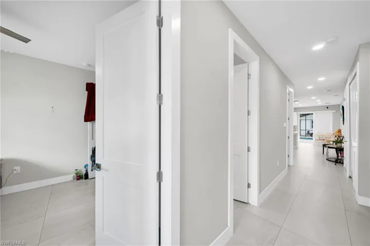 Corridor with recessed lighting and light tile patterned floors