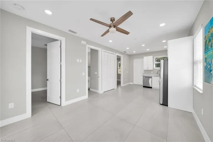 Kitchen featuring stainless steel appliances, a peninsula, healthy amount of natural light, and white cabinetry
