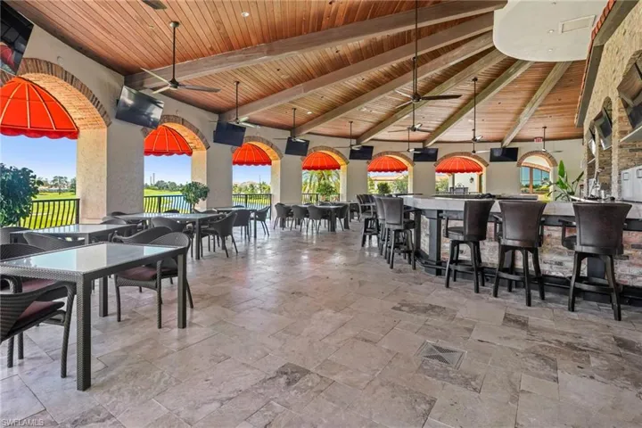 View of patio with ceiling fan and outdoor dining area