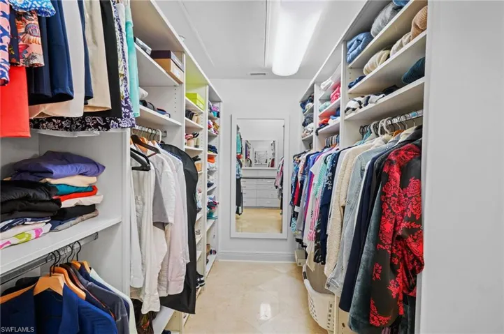 Spacious closet featuring attic access and light tile patterned floors