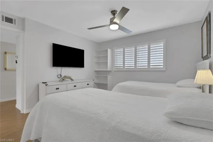 Bright interior space featuring a window with white plantation shutters