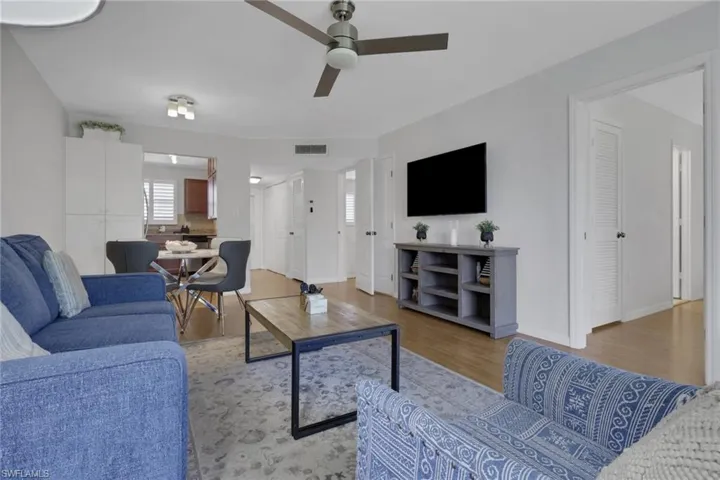 Open-concept living space with wood-finish flooring