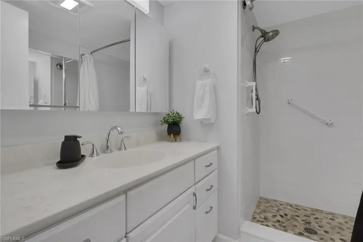 Bathroom featuring a white vanity with an undermount sink and chrome fixtures