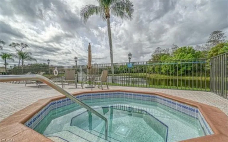 View of pool featuring a hot tub, a patio area, and a swimming pool