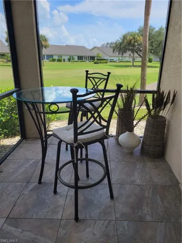 lanai featuring plenty of natural light and view of golf course
