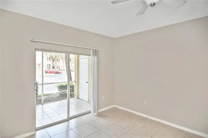 Spare room with light tile patterned flooring and ceiling fan