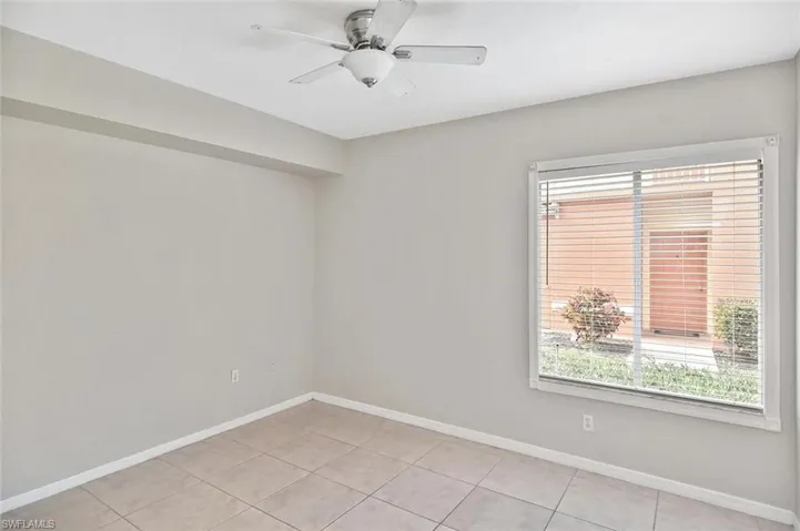 Spare room featuring a ceiling fan and light tile patterned flooring