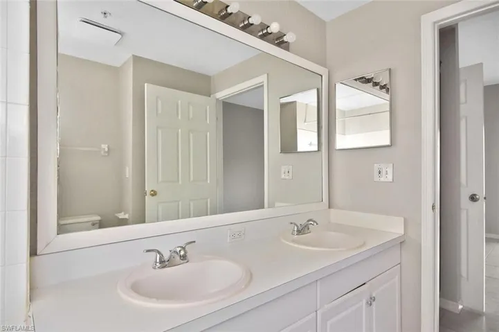 Full bath with double vanity and tile patterned floors