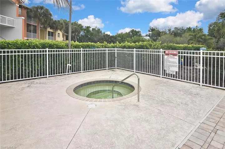 View of pool with a community hot tub