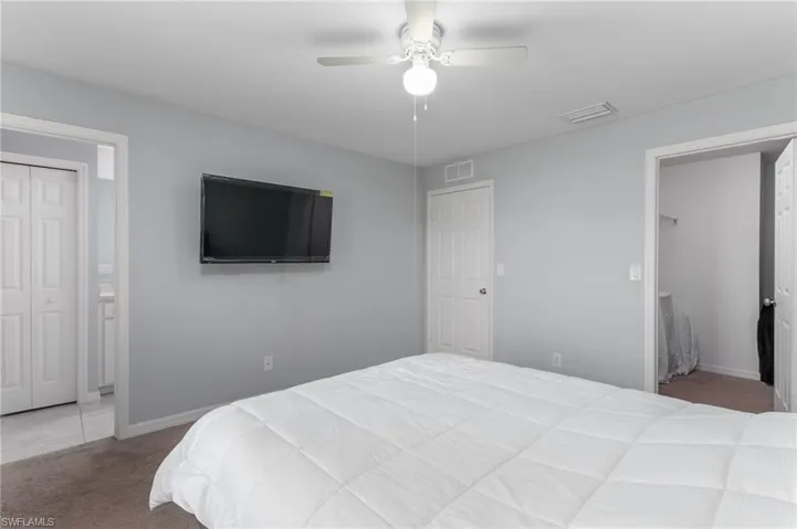 Bedroom featuring baseboards, visible vents, a closet, and carpet flooring
