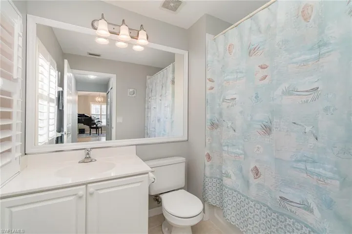 Bathroom featuring toilet, vanity, and tile patterned floors