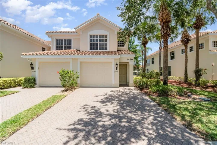 Mediterranean / spanish-style home featuring stucco siding, decorative driveway, a tiled roof, and a garage