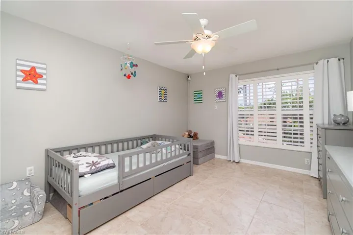 Bedroom with ceiling fan and baseboards