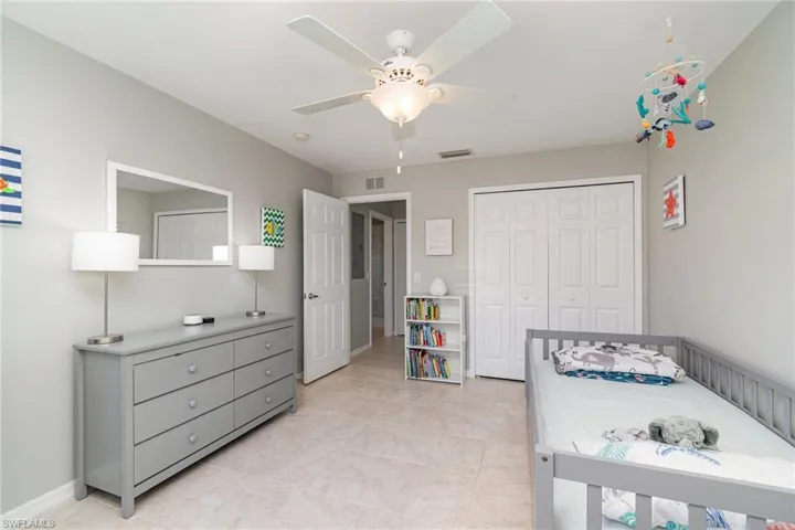 Bedroom featuring a closet, ceiling fan, and baseboards