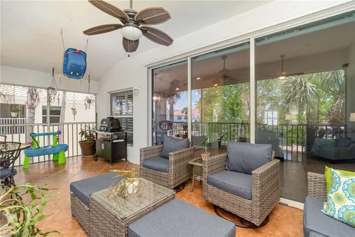 Sunroom with a ceiling fan, vaulted ceiling, and outdoor lounge area