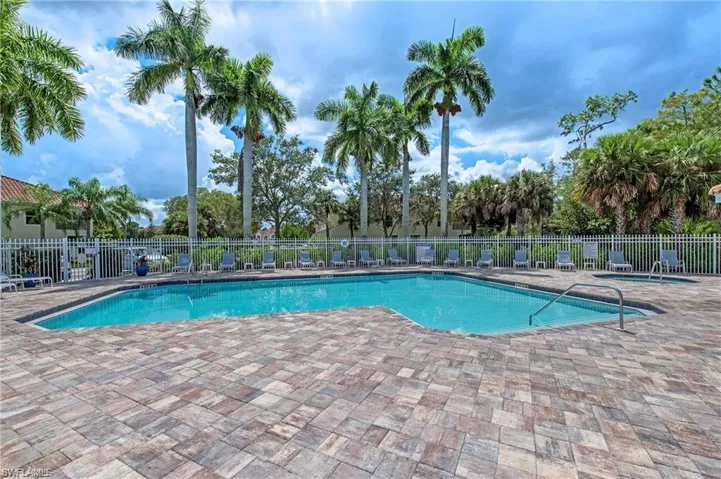 Community pool with a patio