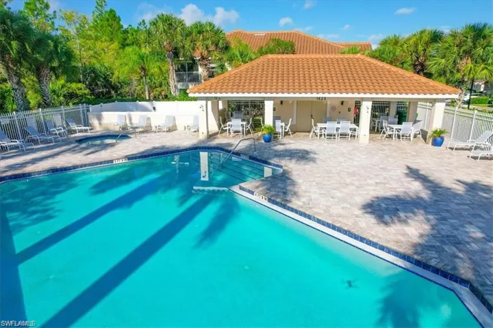 Community pool with a hot tub and a patio