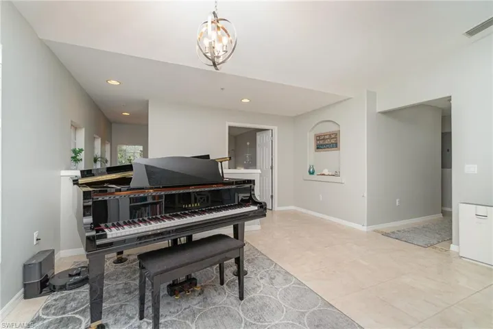 Sitting room featuring recessed lighting, a chandelier, and baseboards