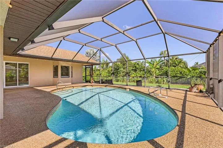 View of swimming pool featuring a patio area and a lanai