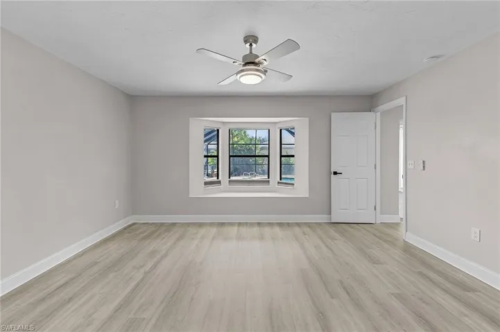 Empty room featuring light hardwood / wood-style flooring and ceiling fan