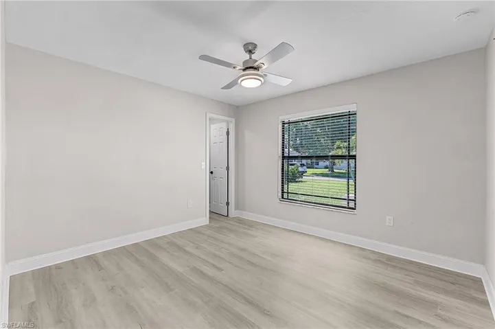 Empty room featuring ceiling fan and light wood-type flooring