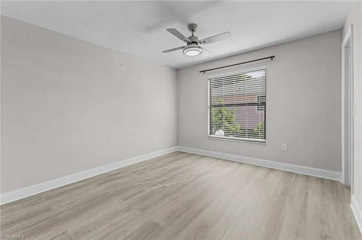 Unfurnished room featuring light wood-type flooring and ceiling fan