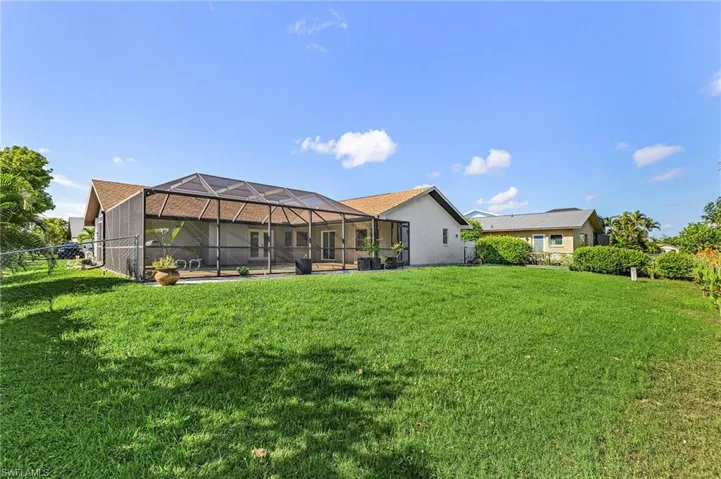 View of yard featuring glass enclosure