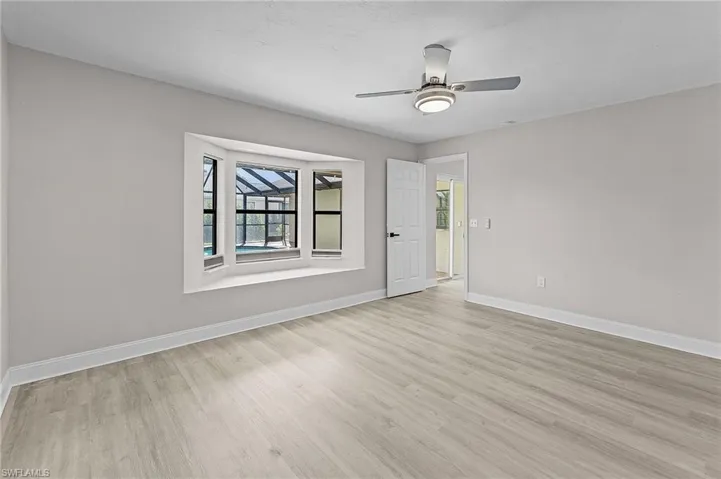 Empty room featuring ceiling fan and light wood-type flooring