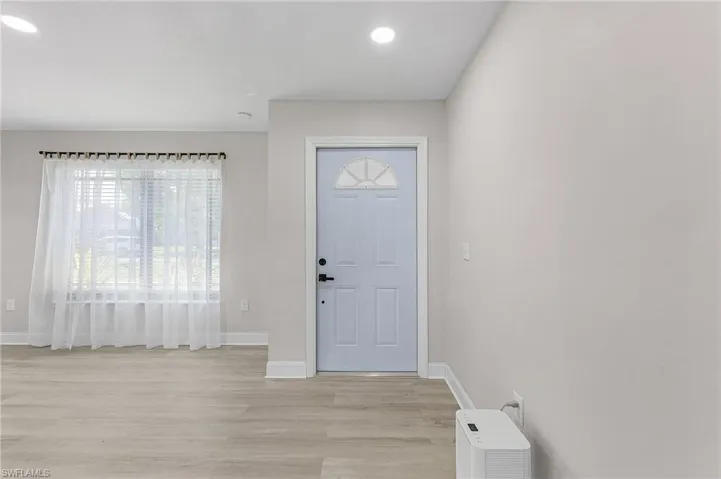 Foyer entrance with light hardwood / wood-style flooring
