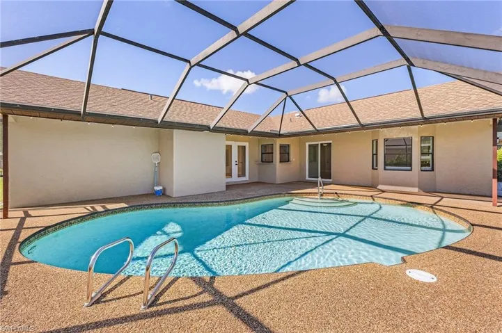 View of pool with a lanai, a patio, and french doors