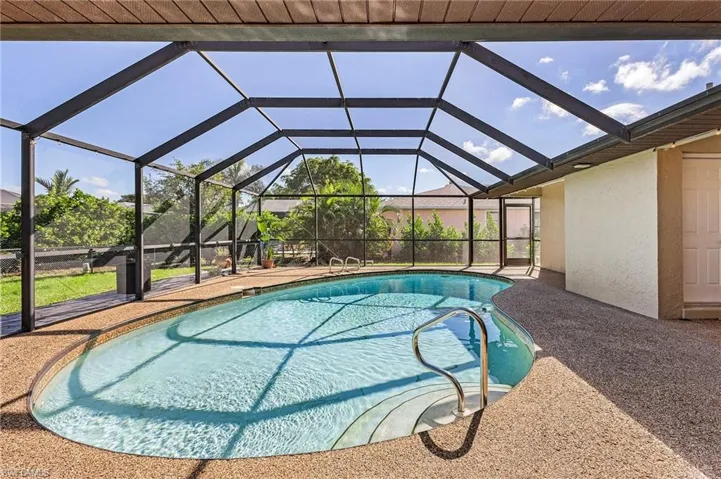 View of swimming pool with glass enclosure