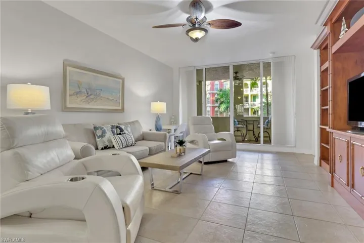 Living area with expansive windows and a ceiling fan