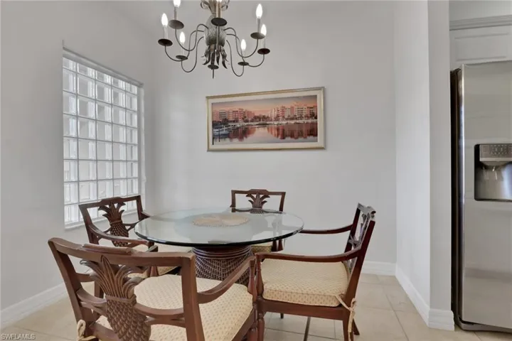 Dining room featuring light tile patterned flooring and a chandelier