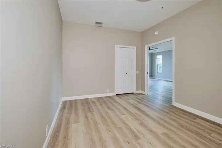 Empty room with light wood-type flooring and baseboards