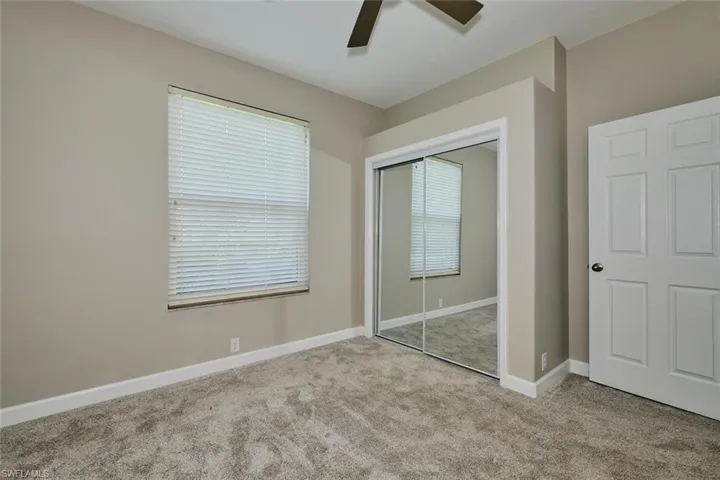 Unfurnished bedroom with carpet flooring, a ceiling fan, and a closet