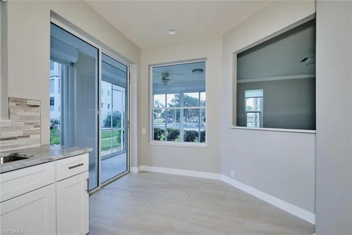 Doorway with baseboards and a ceiling fan