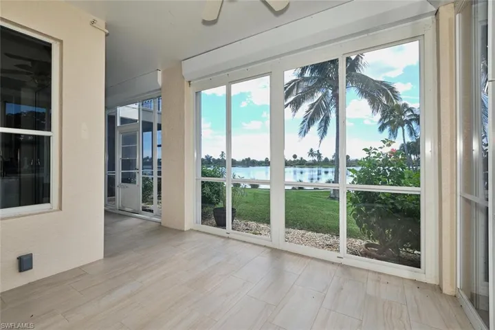 Unfurnished sunroom with a water view